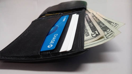 Money and Debit Card in Jean Back Pocket
